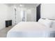 Bright bedroom with a king-size bed and an ensuite bathroom at 10155 Hallendale Dr, Port Charlotte, FL 33981