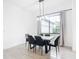 Modern dining room with concrete table and black chairs at 10155 Hallendale Dr, Port Charlotte, FL 33981