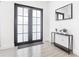 Modern entryway with black-framed glass doors and console table at 10155 Hallendale Dr, Port Charlotte, FL 33981