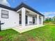 Back exterior showing covered patio and grassy yard at 10155 Hallendale Dr, Port Charlotte, FL 33981