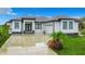 Modern single-story home with gray roof and white walls at 10155 Hallendale Dr, Port Charlotte, FL 33981