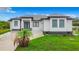 Modern single-story home with gray roof and white walls at 10155 Hallendale Dr, Port Charlotte, FL 33981