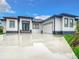 Modern single-story home with gray roof and white walls at 10155 Hallendale Dr, Port Charlotte, FL 33981