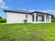 House exterior showcasing backyard and covered patio at 10155 Hallendale Dr, Port Charlotte, FL 33981