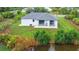 Aerial view of a white house, backyard, and canal at 10155 Hallendale Dr, Port Charlotte, FL 33981