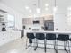 Modern kitchen with white cabinets, quartz countertops, and stainless steel appliances at 10155 Hallendale Dr, Port Charlotte, FL 33981
