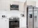 Modern kitchen with stainless steel appliances and white shaker cabinets at 10155 Hallendale Dr, Port Charlotte, FL 33981