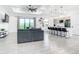 Open living room and kitchen with gray sectional sofa at 10155 Hallendale Dr, Port Charlotte, FL 33981