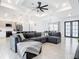 Spacious living area showcasing a sectional sofa, open floor plan, and modern kitchen at 10155 Hallendale Dr, Port Charlotte, FL 33981