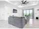 Living area with gray sectional sofa and sliding glass doors at 10155 Hallendale Dr, Port Charlotte, FL 33981