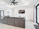 Open living room, featuring a sectional sofa and large TV, with access to the backyard at 10155 Hallendale Dr, Port Charlotte, FL 33981