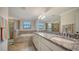 Bathroom with granite countertop, double vanity, and a soaking tub at 10916 Copperlefe Dr, Bradenton, FL 34212