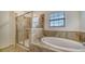Elegant bathroom with a soaking tub and walk-in shower at 10916 Copperlefe Dr, Bradenton, FL 34212