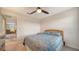 Cozy bedroom with a ceiling fan and dresser, featuring a blue bedding set at 10916 Copperlefe Dr, Bradenton, FL 34212