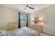 Well-lit bedroom featuring a bed, dresser, and ceiling fan at 10916 Copperlefe Dr, Bradenton, FL 34212