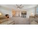 Bonus room with couches, TV, and a ceiling fan at 10916 Copperlefe Dr, Bradenton, FL 34212