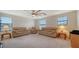 Spacious bonus room with two couches and ceiling fan at 10916 Copperlefe Dr, Bradenton, FL 34212