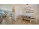 Bright dining room features a wooden table with seating for four and a modern chandelier at 10916 Copperlefe Dr, Bradenton, FL 34212
