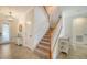 Bright entryway with staircase, tile flooring, and light fixtures at 10916 Copperlefe Dr, Bradenton, FL 34212