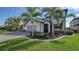Two-story house with gray siding, paver driveway, landscaping, and palm trees at 10916 Copperlefe Dr, Bradenton, FL 34212