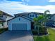 Two-story house with gray siding, paver driveway, and landscaping at 10916 Copperlefe Dr, Bradenton, FL 34212