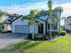 Two-story house with gray siding, paver driveway, and landscaping at 10916 Copperlefe Dr, Bradenton, FL 34212