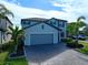 Two-story house with gray siding, paver driveway, and landscaping at 10916 Copperlefe Dr, Bradenton, FL 34212