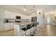 Modern kitchen with white cabinets, granite countertops and island with seating at 10916 Copperlefe Dr, Bradenton, FL 34212