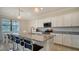 Spacious kitchen with granite countertops, white cabinets, and an island at 10916 Copperlefe Dr, Bradenton, FL 34212