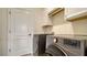 Laundry room with washer, dryer, and cabinets at 10916 Copperlefe Dr, Bradenton, FL 34212
