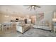 Spacious living room with comfortable seating, open to kitchen and dining areas at 10916 Copperlefe Dr, Bradenton, FL 34212