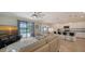 Open living space with a view of the kitchen, pool, and flat-screen TV at 10916 Copperlefe Dr, Bradenton, FL 34212