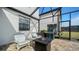 Outdoor patio with fire pit, seating, and grill at 10916 Copperlefe Dr, Bradenton, FL 34212