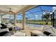 Screened pool and patio area with seating and a view of the lake at 10916 Copperlefe Dr, Bradenton, FL 34212