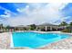 Community pool with a covered patio and lounge chairs at 10916 Copperlefe Dr, Bradenton, FL 34212