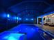 Enclosed pool and spa with lighting and seating area at 10916 Copperlefe Dr, Bradenton, FL 34212