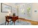 Bright entryway with hardwood floors, wooden desk, and framed art at 115 Edmondson Ave, Sarasota, FL 34242