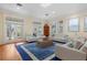 Bright living room featuring hardwood floors, white sofas, and French doors at 115 Edmondson Ave, Sarasota, FL 34242