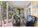 Relaxing screened porch with wicker furniture at 115 Edmondson Ave, Sarasota, FL 34242