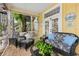 Relaxing screened porch with wicker furniture at 115 Edmondson Ave, Sarasota, FL 34242