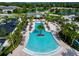 Aerial view of resort-style pool with palm trees and lounge chairs at 11728 Meadowgate Pl, Bradenton, FL 34211