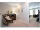 Upstairs sitting area with rocking chair and built-in shelving at 11728 Meadowgate Pl, Bradenton, FL 34211
