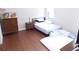 Bedroom with hardwood floors and a dresser at 11992 Blazing Star Dr, Venice, FL 34293