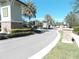 Landscaped entrance to a residential community with palm trees and stonework at 11992 Blazing Star Dr, Venice, FL 34293