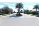 Gated entrance to a community with palm trees and landscaping at 11992 Blazing Star Dr, Venice, FL 34293