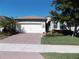 Single-story house with a paved driveway, landscaping, and a two-car garage at 11992 Blazing Star Dr, Venice, FL 34293