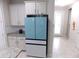 Kitchen features a light blue refrigerator and granite countertops at 11992 Blazing Star Dr, Venice, FL 34293