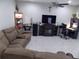 Spacious living room with a sectional sofa, large TV, and fireplace at 11992 Blazing Star Dr, Venice, FL 34293