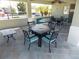 Community patio with tables and chairs for relaxing at 11992 Blazing Star Dr, Venice, FL 34293