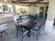 Community patio with tables and chairs for relaxing at 11992 Blazing Star Dr, Venice, FL 34293